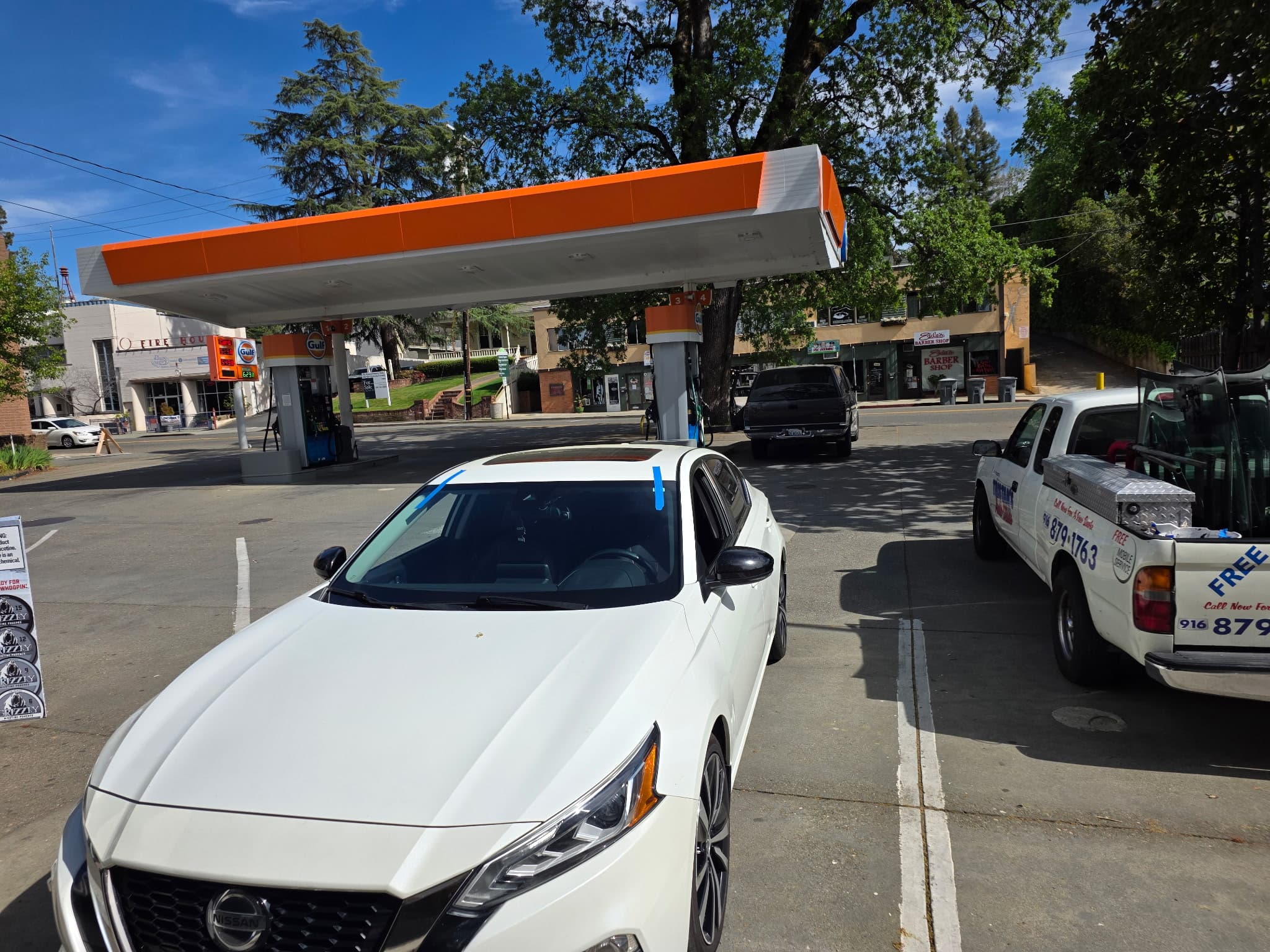 Nissan windshield install at a gas station
